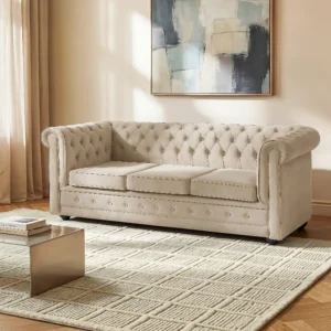 Canapé Chesterfield convertible beige en velours avec dossier capitonné et accoudoirs